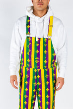 Load image into Gallery viewer, A person in Mardi Gras overalls ready for a festive day, with a front pocket for beignets.