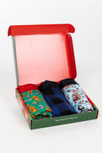 Load image into Gallery viewer, A box with a pair of socks and underwear, blankets, and Christmas pajamas.