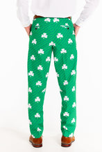 Load image into Gallery viewer, A person in St. Patrick's Day pants with clovers, a close-up of a shoe.