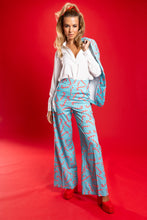 Load image into Gallery viewer, A woman in candy cane patterned suit pants.