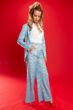 Load image into Gallery viewer, A woman in a unique candy cane blazer, exuding holiday vibes with a bow in her hair.