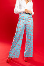 Load image into Gallery viewer, A person in The Peppermint Pimp Canes pants and a red shoe, close-up of fashion details.