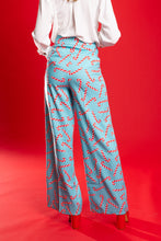 Load image into Gallery viewer, A person in candy cane patterned pants, standing confidently.