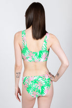 Load image into Gallery viewer, A woman in The Piña Colada | Tropical Coconuts Bikini Bottoms, enjoying a Miami Vice cocktail.