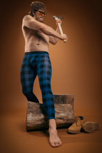 Load image into Gallery viewer, A man in royal blue Ball Hammock¬Æ long johns holding a hammer on a log.
