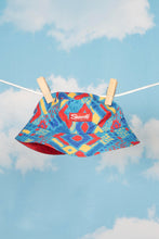 Load image into Gallery viewer, Reversible bucket hat on a clothesline with a label and clothespin.
