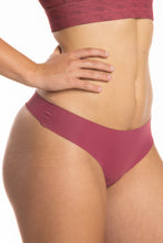 Load image into Gallery viewer, A close-up of a woman wearing The Bordeaux | Mauve Seamless Thong Underwear.
