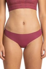 Load image into Gallery viewer, A close-up of The Bordeaux | Mauve Seamless Thong Underwear on a woman&#39;s body, showcasing the garment&#39;s seamless design and delicate style.
