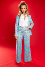 Load image into Gallery viewer, A woman in a unique candy cane patterned suit by Shinesty, exuding a bold and playful fashion statement.
