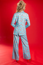 Load image into Gallery viewer, A woman in The Peppermint Pimp Canes suit with candy cane pattern, exuding bold fashion vibes.
