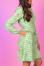Load image into Gallery viewer, A woman in a Derby Horse Racing Stripe Wrap Dress.
