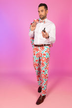 Load image into Gallery viewer, A man in floral pants holding a pipe and bow tie.
