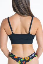 Load image into Gallery viewer, A woman in The Threat Level Midnight Black Strappy Bralette.
