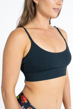 Load image into Gallery viewer, A close-up of The Threat Level Midnight Black Strappy Bralette on a woman&#39;s body.
